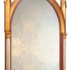 gilded gold frame and the gothic arched ogee shape on the mirror.